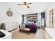 Main bedroom with accent wall, bench seat, and stylish decor at 2611 Burwood Ave, Orlando, FL 32837