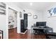 Open office space with dark wood floors, dual monitors, shelving, and view into hallway at 2611 Burwood Ave, Orlando, FL 32837