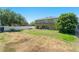 Large, fenced backyard features a view of the home's rear exterior and mature trees at 2644 Slagrove Ct, Winter Garden, FL 34787