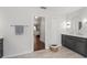 Neutral bathroom features a sink vanity, tile floors, a towel rack and an open doorway at 2644 Slagrove Ct, Winter Garden, FL 34787