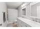 Bathroom features a double sink vanity with white countertop and a framed mirror at 2644 Slagrove Ct, Winter Garden, FL 34787