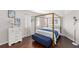 Bedroom featuring a four-poster bed, wood floors, white walls, and natural light at 2644 Slagrove Ct, Winter Garden, FL 34787