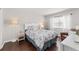 Bedroom featuring a decorative upholstered headboard, wood floors, and a bright window at 2644 Slagrove Ct, Winter Garden, FL 34787