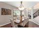 Dining room showcasing hardwood floors, large windows, and staircase at 2644 Slagrove Ct, Winter Garden, FL 34787