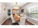 Spacious dining room featuring hardwood floors, modern lighting, and a china cabinet at 2644 Slagrove Ct, Winter Garden, FL 34787