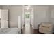 The hallway features hardwood floors and neutral paint leading to a window with a garden view at 2644 Slagrove Ct, Winter Garden, FL 34787