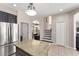 This kitchen features dark cabinets, stainless steel appliances, granite countertops, with a view of the stairs at 2644 Slagrove Ct, Winter Garden, FL 34787