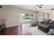 Bright living room with hardwood flooring, neutral paint, and slider to the backyard at 2644 Slagrove Ct, Winter Garden, FL 34787