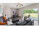 Spacious living room featuring wood floors, fan, and sliding door to backyard at 2644 Slagrove Ct, Winter Garden, FL 34787