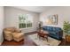 Cozy living room featuring hardwood floors, a leather sofa, and natural light at 2644 Slagrove Ct, Winter Garden, FL 34787
