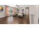 Open-concept living room with hardwood floors, large windows, neutral paint, and a comfortable couch at 2644 Slagrove Ct, Winter Garden, FL 34787