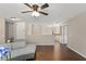 Loft featuring hardwood floors, neutral paint, with a comfortable couch and iron banister at 2644 Slagrove Ct, Winter Garden, FL 34787