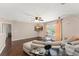 Loft featuring hardwood floors, neutral paint, with a comfortable couch and an entertainment center at 2644 Slagrove Ct, Winter Garden, FL 34787
