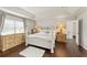 The main bedroom has a tray ceiling, hardwood floors, neutral paint, and a luxurious bed at 2644 Slagrove Ct, Winter Garden, FL 34787