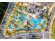 Resort-style community featuring pools, a lazy river, a clubhouse, and lush landscaping as seen from above at 3009 Penelope Loop, Kissimmee, FL 34746