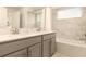 Bright bathroom with double sinks, modern fixtures, vanity and soaking tub, ideal for relaxation at 3009 Penelope Loop, Kissimmee, FL 34746