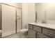 Modern bathroom with a glass-enclosed shower, white cabinets and marble tile floor at 3009 Penelope Loop, Kissimmee, FL 34746
