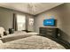 Bedroom featuring two beds with gray bedding, and a mounted TV above a dark dresser at 3009 Penelope Loop, Kissimmee, FL 34746