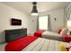 Bright bedroom featuring twin beds, grey bedding with red accents and a mounted TV at 3009 Penelope Loop, Kissimmee, FL 34746