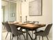 Contemporary dining space with seating for six, set on a wooden table with decorative place settings at 3009 Penelope Loop, Kissimmee, FL 34746