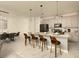 Bright kitchen with an island, seating, stainless steel appliances and open to the dining area at 3009 Penelope Loop, Kissimmee, FL 34746