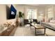Cozy living room with a comfortable sofa, modern chairs, wooden coffee table, and a view of the pool at 3009 Penelope Loop, Kissimmee, FL 34746