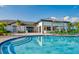 Community pool featuring clear water with chairs for lounging and a snack bar at 3009 Penelope Loop, Kissimmee, FL 34746