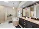 Bright bathroom featuring double sinks, granite countertops, large mirror, bathtub and walk-in shower at 324 Old Mill Rd, Enterprise, FL 32725