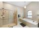 Bright bathroom with a walk-in shower, soaking tub, and neutral tile at 324 Old Mill Rd, Enterprise, FL 32725