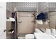 Cozy bathroom features a shower, patterned wallpaper, toilet, and a modern white sink at 324 Old Mill Rd, Enterprise, FL 32725