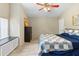 Spacious bedroom features a ceiling fan, wood floors, window bench, and dark wooden dresser at 324 Old Mill Rd, Enterprise, FL 32725