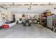 Spacious garage featuring work bench, tool storage, and room for a riding mower at 324 Old Mill Rd, Enterprise, FL 32725