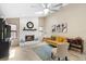 Inviting living room with a white brick fireplace, plush seating, and ample natural light at 324 Old Mill Rd, Enterprise, FL 32725