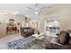 Bright living room with tile floors, modern ceiling fan, and stylish furnishings at 324 Old Mill Rd, Enterprise, FL 32725