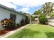 Spacious backyard featuring a pergola-covered seating area, lush greenery, and meticulous landscaping at 3317 Dormer Ct, Winter Park, FL 32792