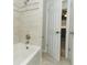 A clean bathroom shows a tile shower and open doorway to a bedroom with neutral walls at 3317 Dormer Ct, Winter Park, FL 32792