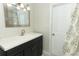 Bathroom featuring a single sink vanity, decorative mirror and a shower and tub combination at 3317 Dormer Ct, Winter Park, FL 32792