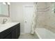 Bathroom featuring a single sink vanity, decorative mirror and a shower and tub combination at 3317 Dormer Ct, Winter Park, FL 32792