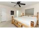 Bedroom featuring ceiling fan, neutral carpet and paint, and wood framed bed at 3317 Dormer Ct, Winter Park, FL 32792