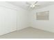 Bright bedroom with neutral carpet, white walls, a ceiling fan, and a double-door closet at 3317 Dormer Ct, Winter Park, FL 32792
