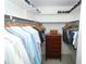 Spacious walk-in closet with ample hanging space, shelving, and a wooden chest of drawers at 3317 Dormer Ct, Winter Park, FL 32792