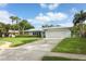 Charming single-story home with a wide driveway, two-car garage and tropical landscaping at 3317 Dormer Ct, Winter Park, FL 32792