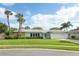Charming single-story home featuring a well-manicured lawn, palm trees, and a two-car garage at 3317 Dormer Ct, Winter Park, FL 32792