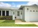 Close-up of the home's facade, highlighting the front door, landscaping, and attached garage at 3317 Dormer Ct, Winter Park, FL 32792