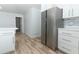 Modern kitchen with stainless steel refrigerator, white cabinets, and bright lighting at 3317 Dormer Ct, Winter Park, FL 32792