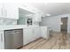 Stylish kitchen with stainless steel dishwasher, skylight, and breakfast bar with seating at 3317 Dormer Ct, Winter Park, FL 32792