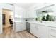 Modern kitchen featuring white cabinets, stainless steel appliances, and wood-look flooring at 3317 Dormer Ct, Winter Park, FL 32792
