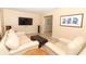 Inviting living room with wood-look floors, a large flat-screen TV, and comfortable seating at 3317 Dormer Ct, Winter Park, FL 32792