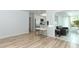 Open living space with access to modern kitchen and sunroom with seating at 3317 Dormer Ct, Winter Park, FL 32792