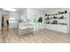 Spacious living room with built-in shelving, wood floors, and access to sunroom and kitchen at 3317 Dormer Ct, Winter Park, FL 32792